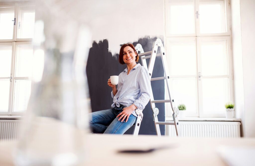 woman sitting in front of wall paint
